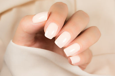 Light manicure in light on a pink backgr